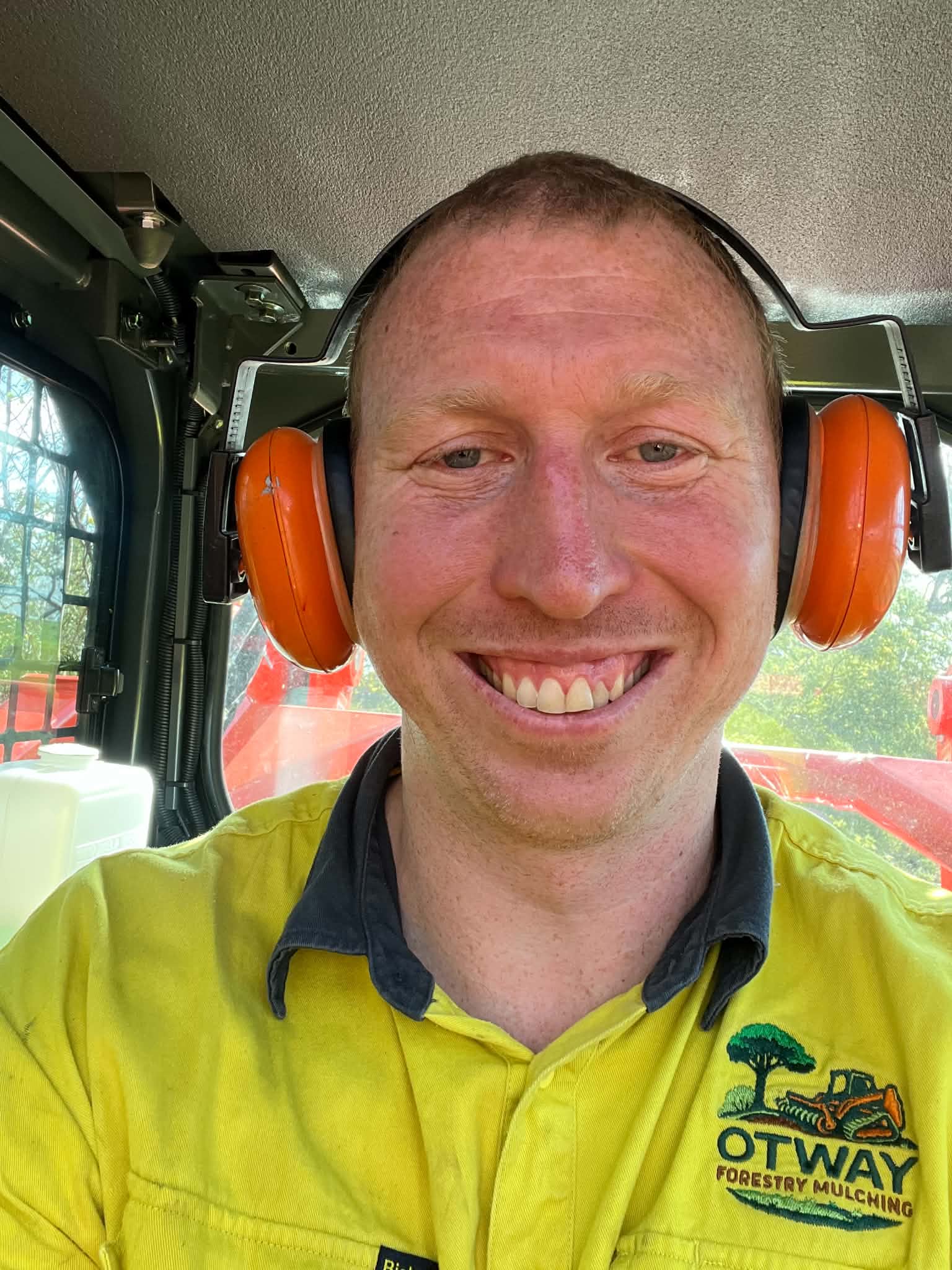 Lachy smiling inside the cab of the new Kubota skid steer